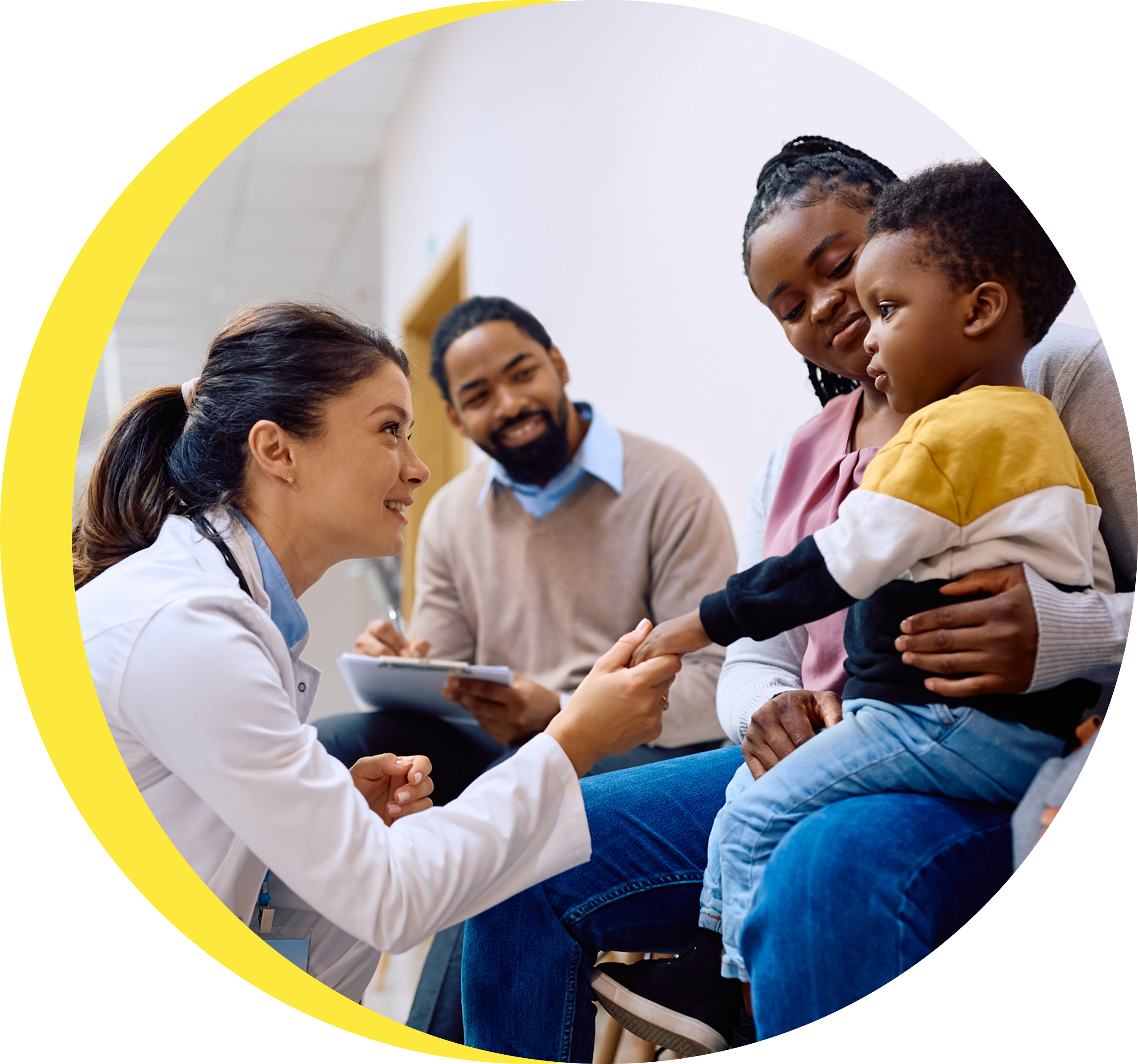 A doctor is holding a child and talking to them.